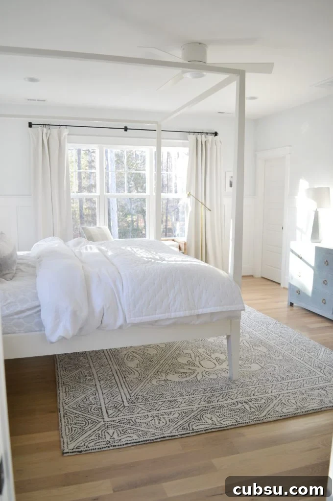 white drapes in an all white bedroom