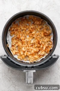 Crispy Oven and Air Fryer Rice: Step-by-Step Guide for Crunchy Rice 7 Cooked crispy rice in a parchment-lined air fryer.