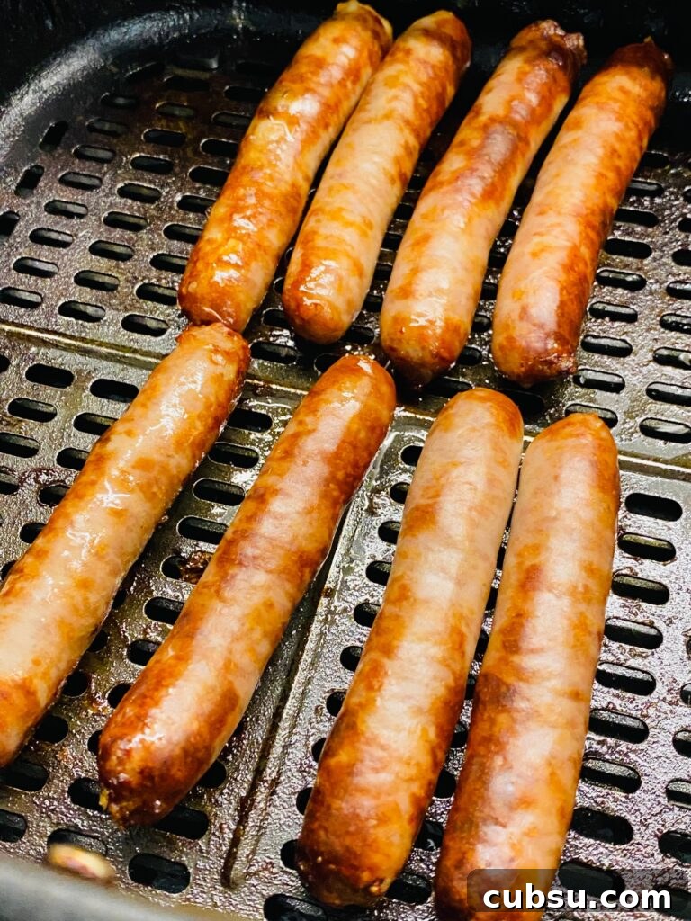Savory Breakfast Pigs in a Blanket Recipe for Busy Mornings 3 Cooked sausage links in the air fryer