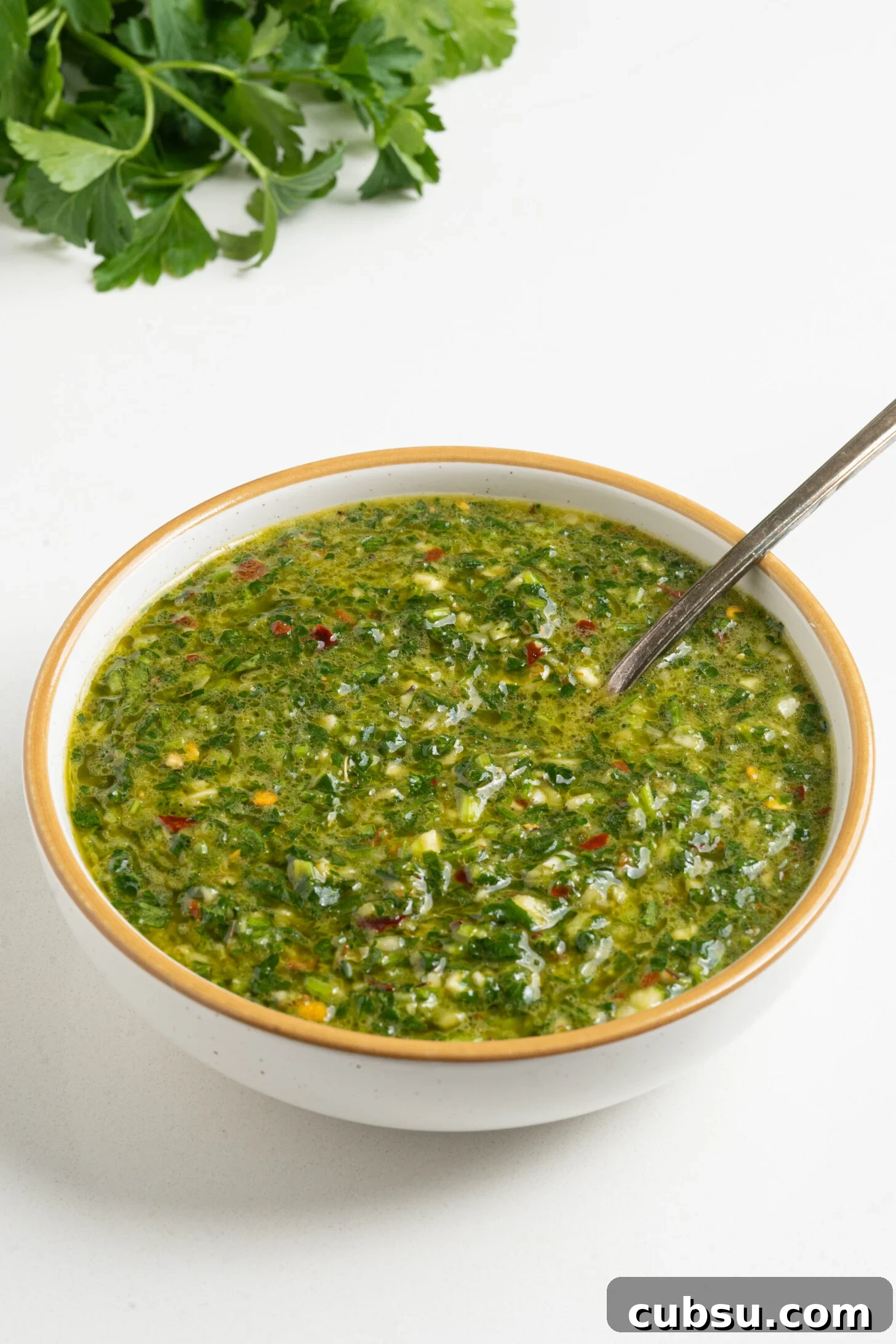 A bowl of chimichurri sauce.