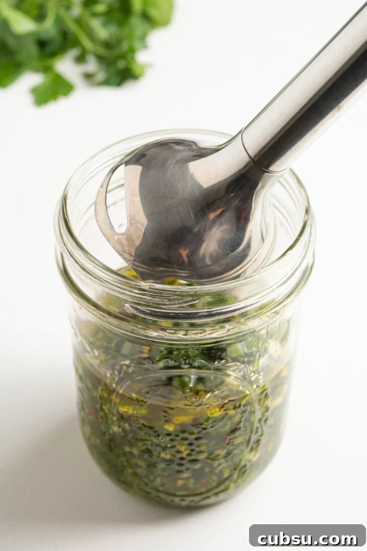 A jar of chimichurri sauce about to be blended.