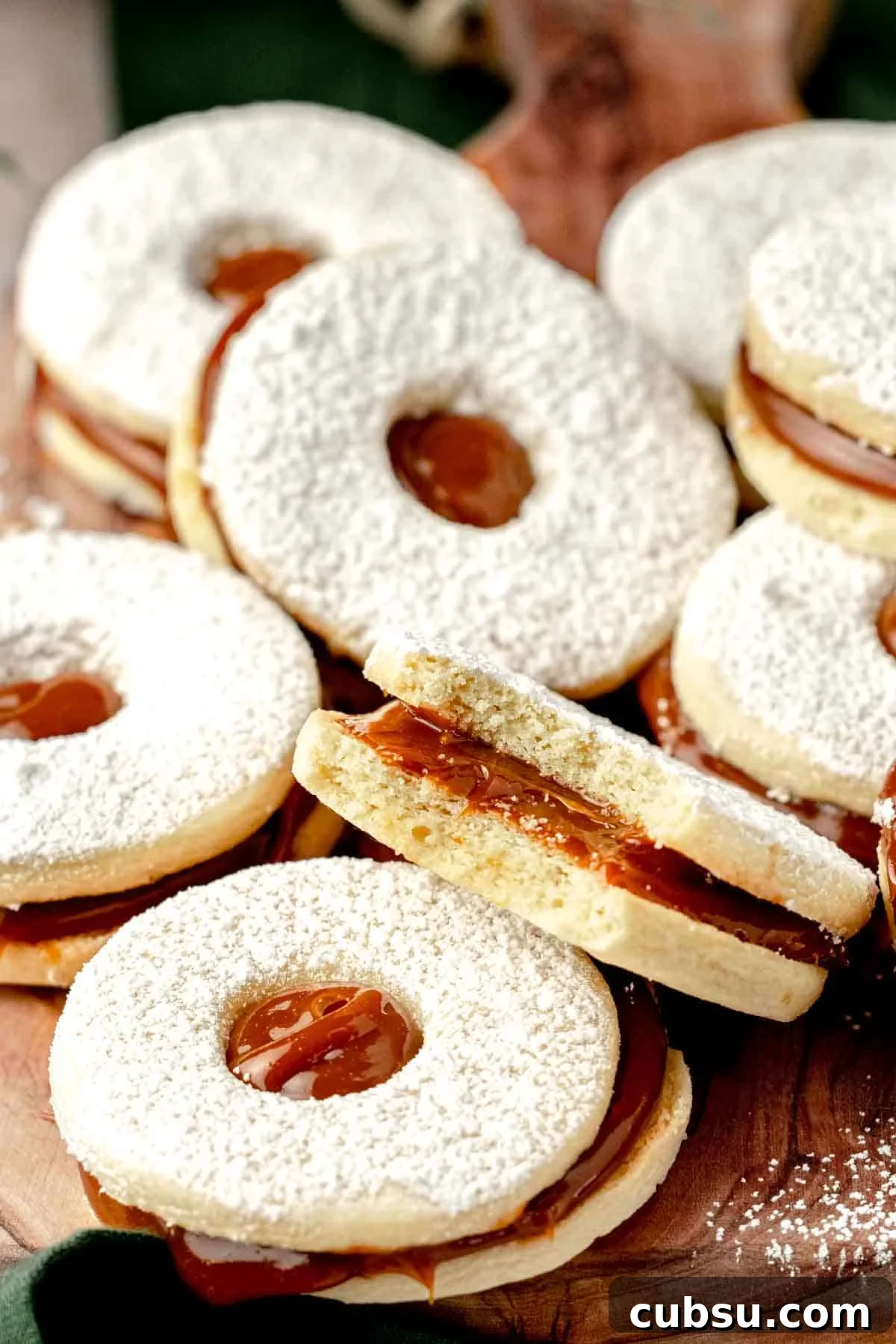 bitten dulce de leche filled cookies on cutting board