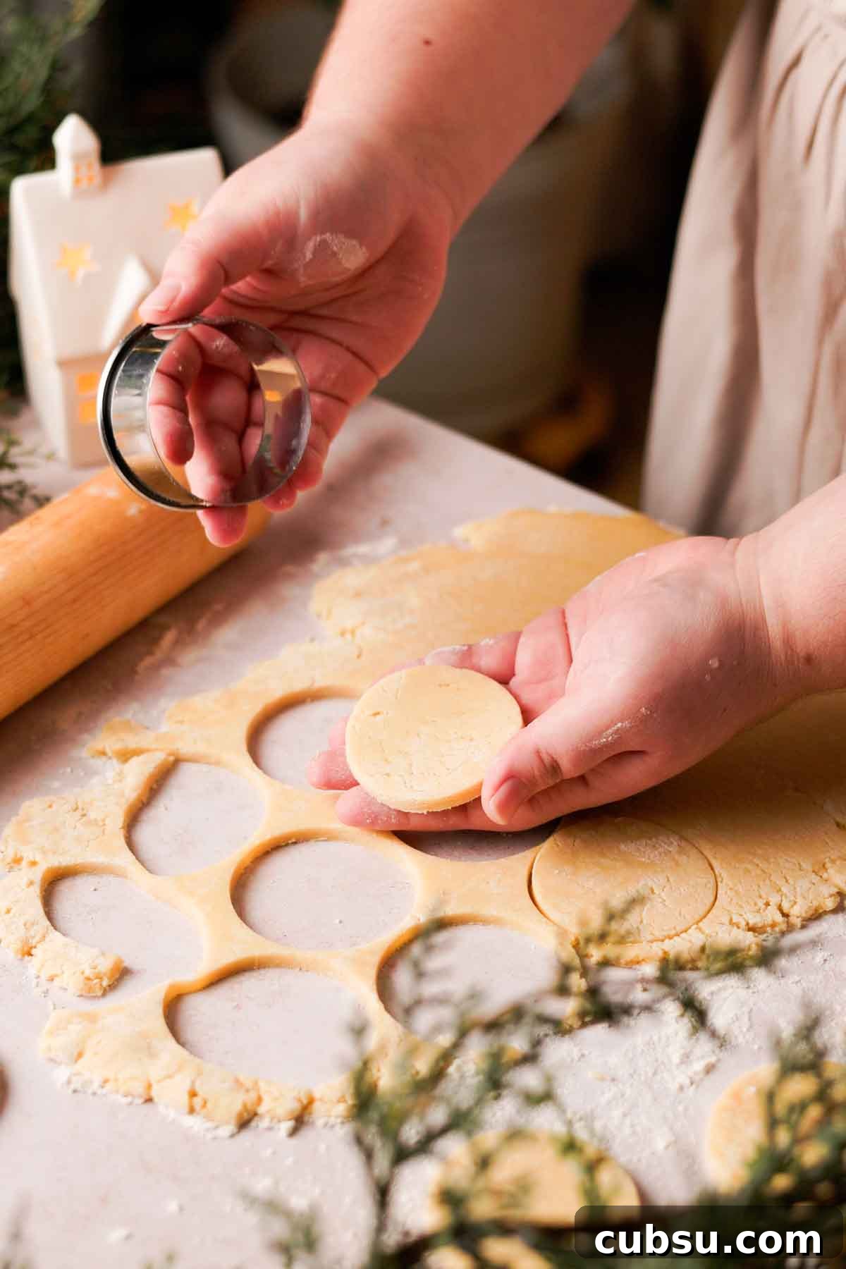 cutting cookies with round cookie cutter