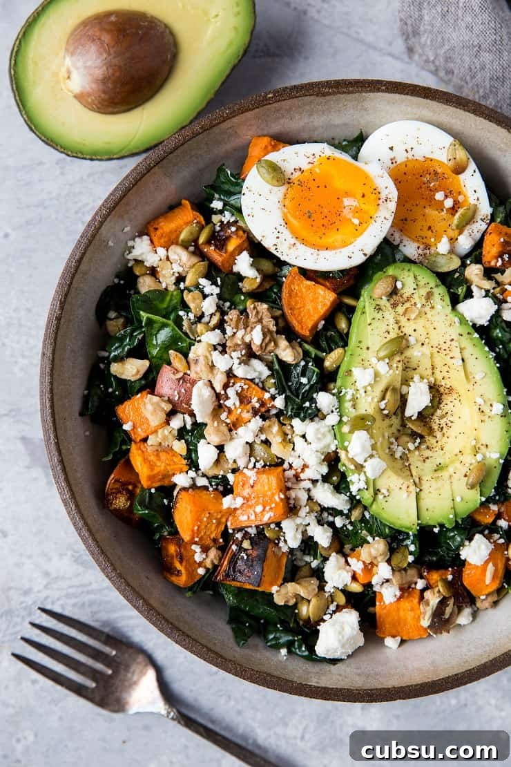 Roasted Sweet Potato Kale Salad with Avocado, Jammy Egg, Pumpkin Seeds, and Walnuts. A filling and nutritious dinner salad | TheRoastedRoot.net