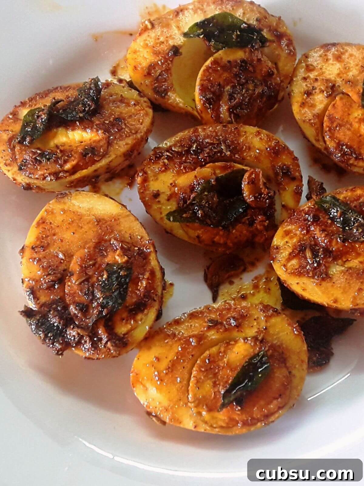 Crispy Pan-Fried Boiled Eggs with Spices — Quick Recipe 2 egg fry served in a plate.
