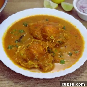 Mangalorean egg drop curry with two eggs on a serving plate.