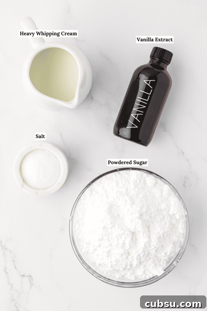 overhead view of the ingredients for vanilla glaze including a white dish full of heavy whipping cream, a bottle of vanilla extract, a small white bowl of salt and a large glass bowl of powdered sugar