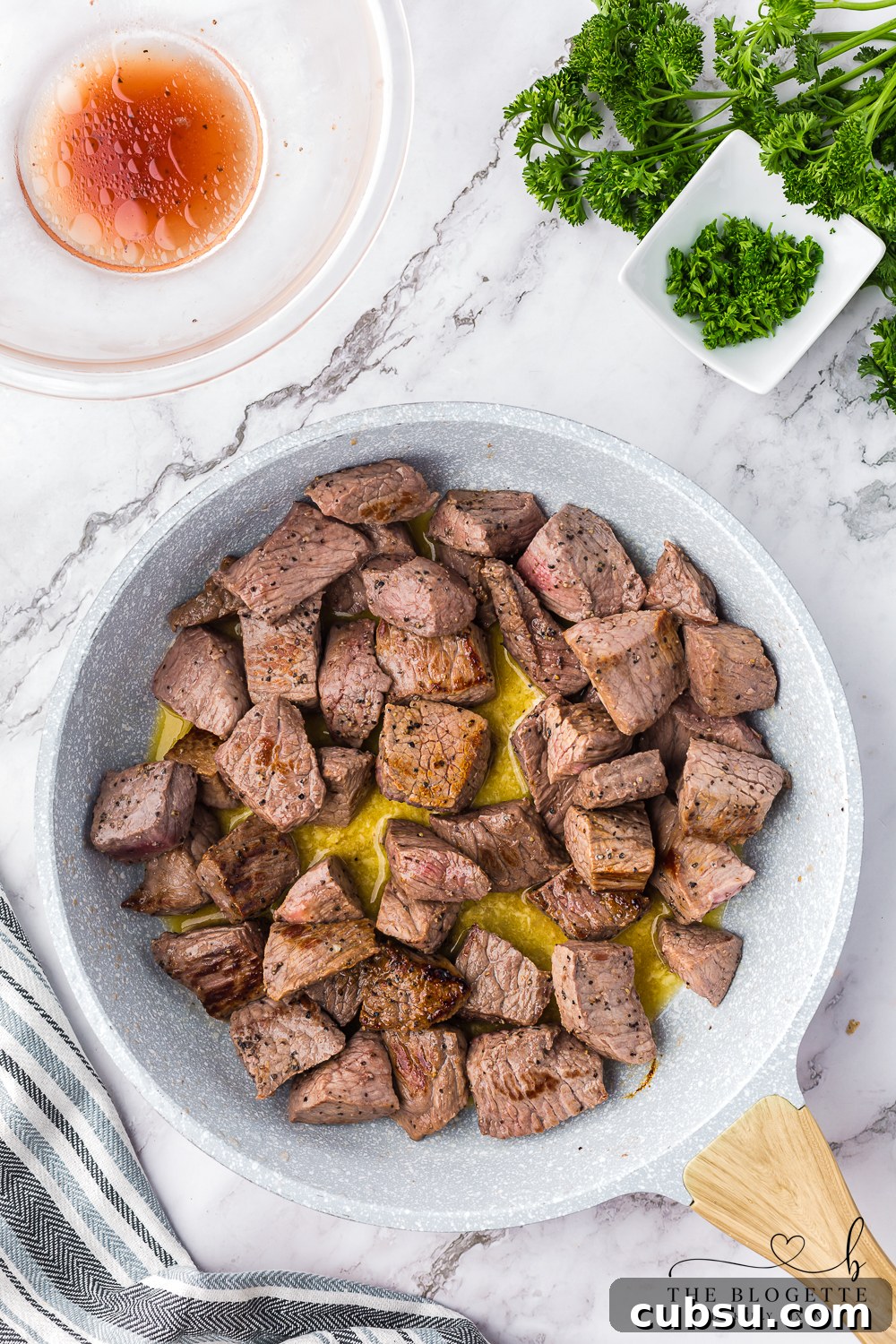Garlic Butter Steak Bites Recipe: Tender Seared Beef with Herb Sauce 8 Cooking steak cubes in melted butter and garlic