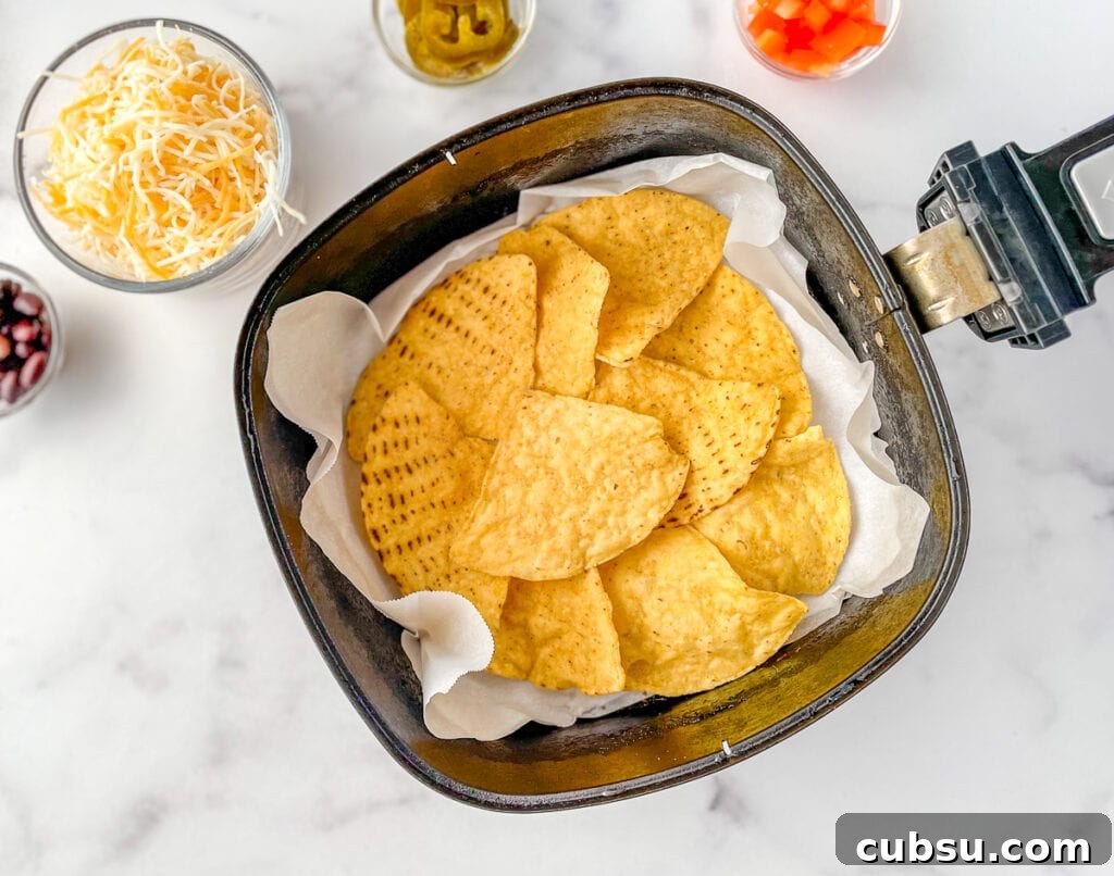 Arrange the tortilla chips in a single layer in the air fryer basket