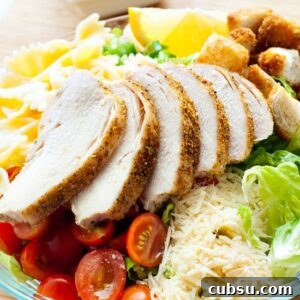 Delicious Caesar Salad on a plate with croutons. tomatoes and fresh Parmesan.
