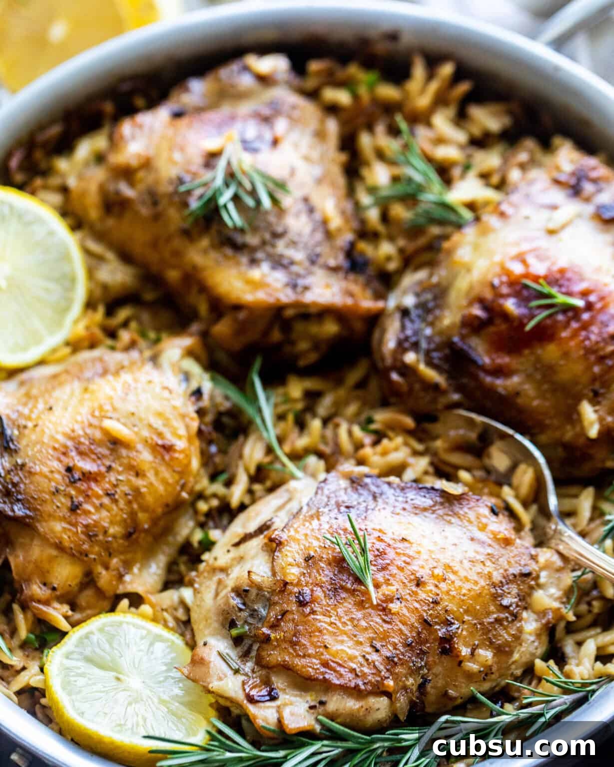 Rosemary Roasted Chicken with Creamy Parmesan Orzo 3 chicken and orzo in a large pan with lemons
