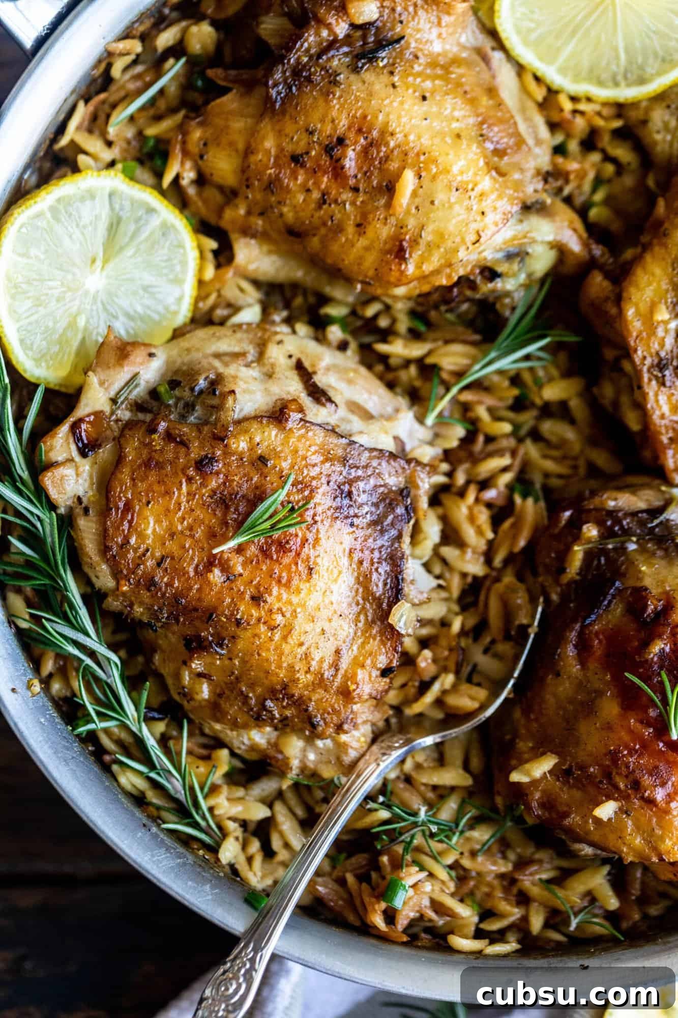 Rosemary Roasted Chicken with Creamy Parmesan Orzo 5 chicken and orzo in a pan with rosemary and lemon