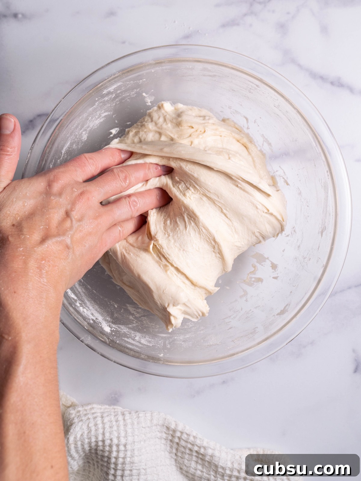 Rosemary Sea Salt Sourdough Bread Recipe for Crispy Crust 5 Folding sourdough to build tension