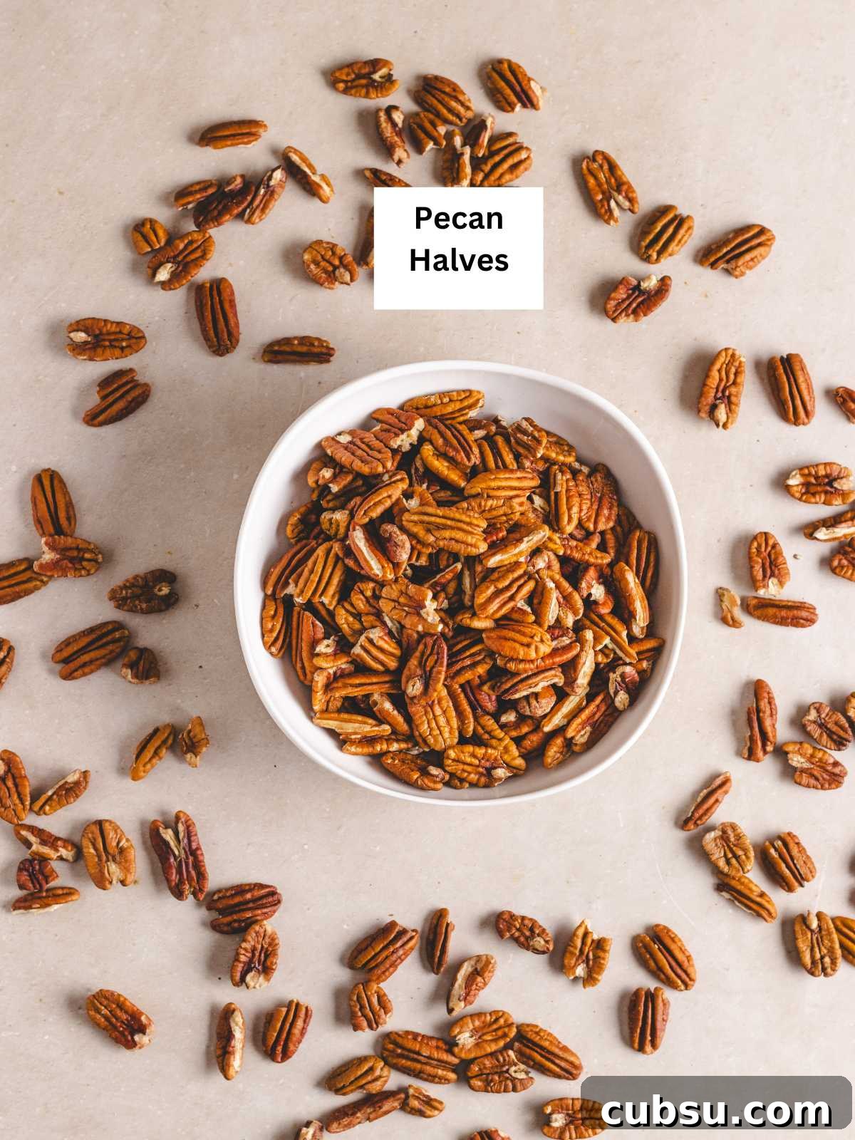 How to Make Pecan Flour at Home for Baking and Paleo Recipes 3 Pecan halves in a shallow bowl.