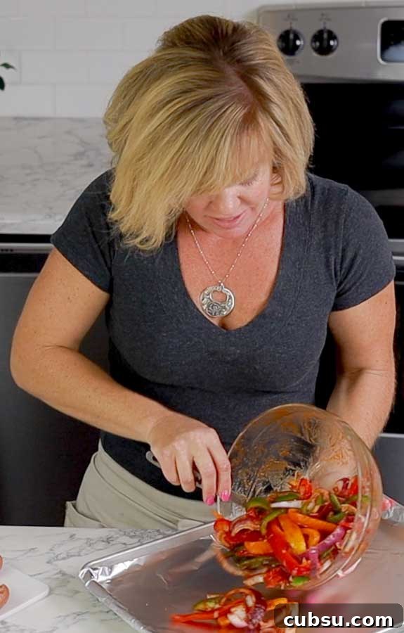 Jennifer pouring peppers on baking sheet