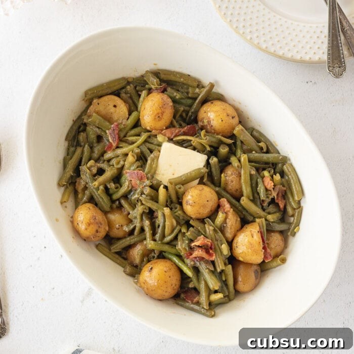 Weekly Meal Plan: Sept 3–9, 2024 – 7-Day Dinners & Prep Guide 24 Overhead view of green beans and potatoes in a serving dish with a pat of butter melting on top.