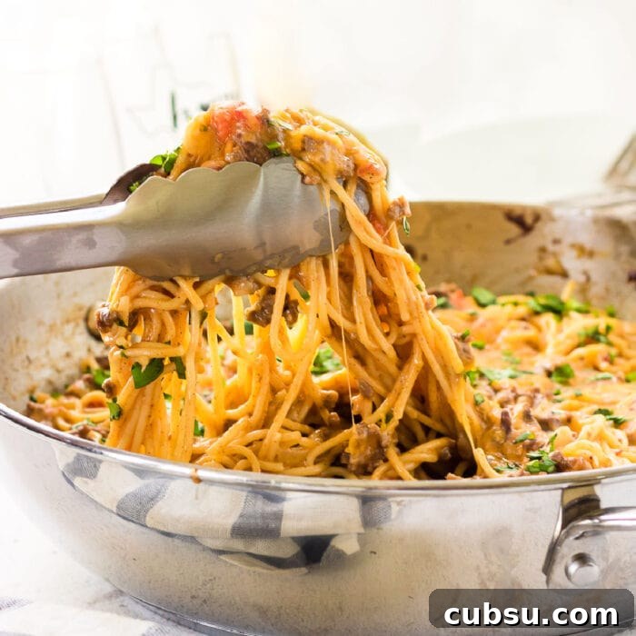 Weekly Meal Plan: Sept 3–9, 2024 – 7-Day Dinners & Prep Guide 4 A closeup of tongs lifting a serving of taco spaghetti out of the pan.