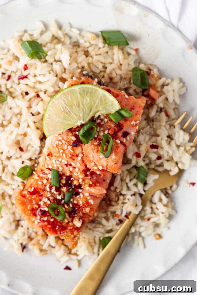 Week 21 Paleo Meal Plan: 7-Day Recipes & Grocery List 4 honey sriracha salmon on a plate with rice and a fork