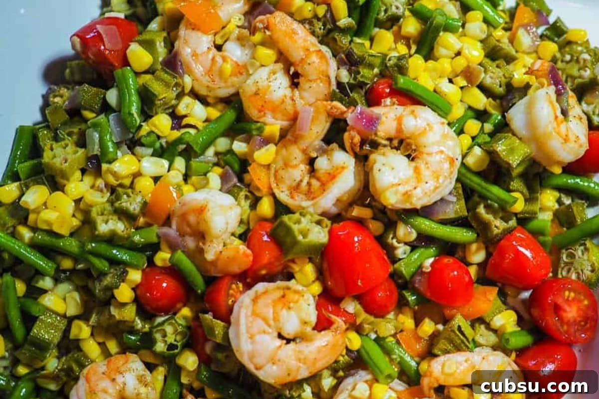 8 Must-Try Okra Recipes to Savor Before Summer Ends 8 A colorful dish featuring sautéed shrimp alongside green beans, corn, okra, and cherry tomatoes, showcasing a mix of vibrant vegetables.
