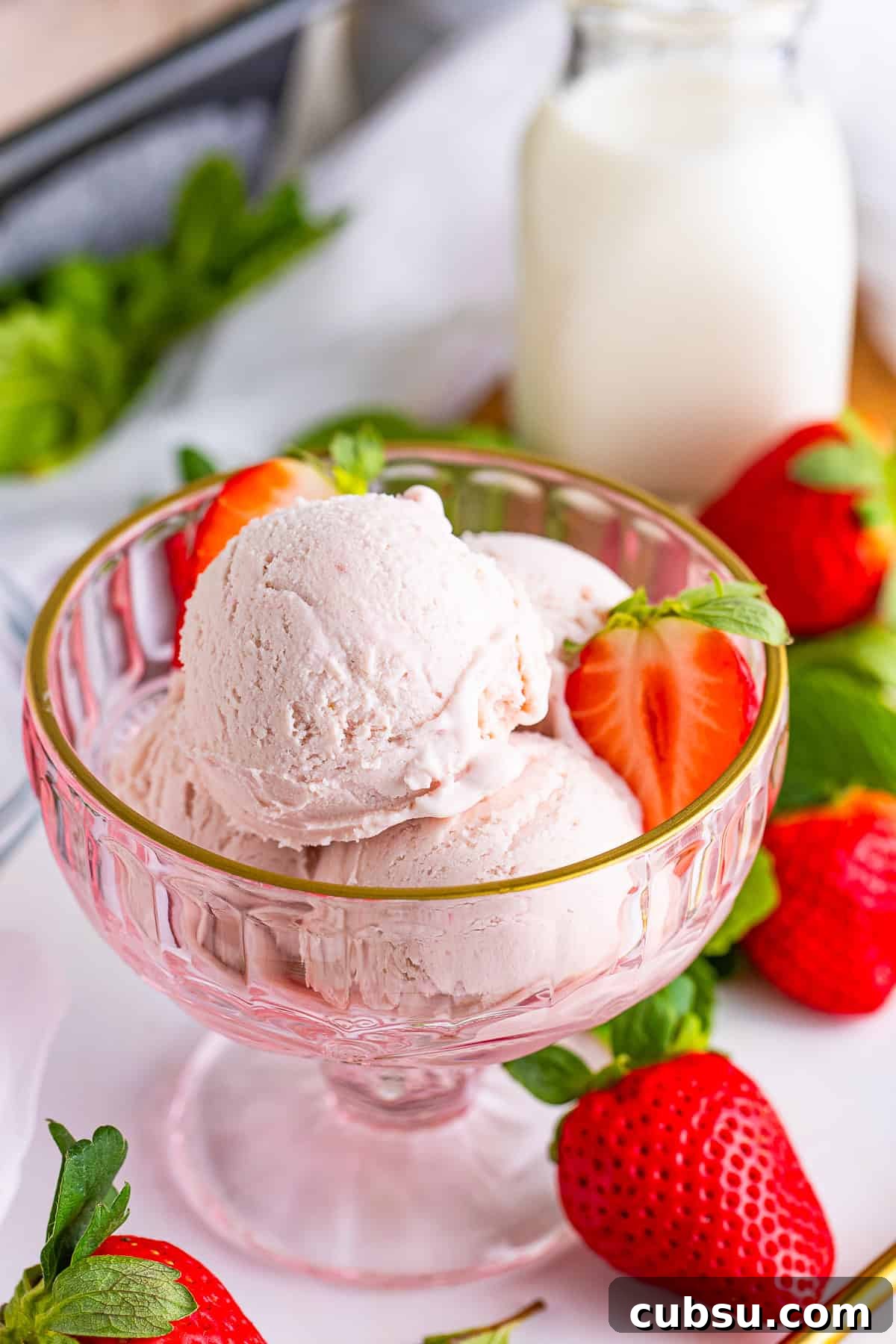 Strawberry ice cream served in a pink glass bowl