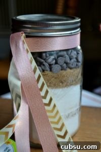 Jar of dry ingredients for Mason Jar Chocolate Chips Mania cookies