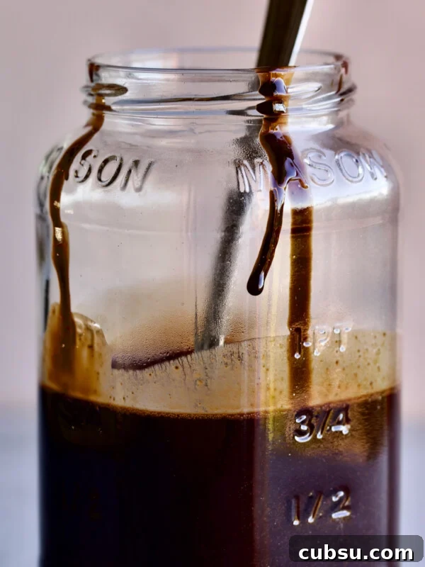 Christiane’s Classic Chocolate Mousse Recipe 5 chocolate syrup in Mason jar with drip. Spoon inside jar.