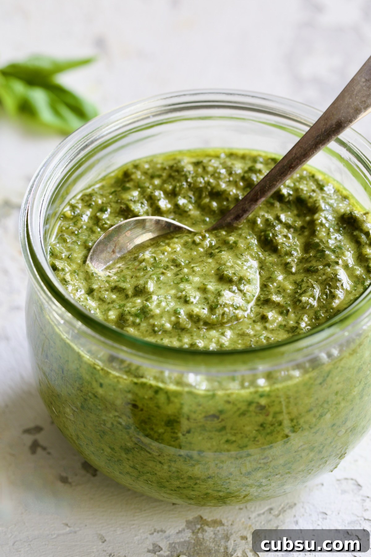 Jar of Pesto Genovese with spoon.