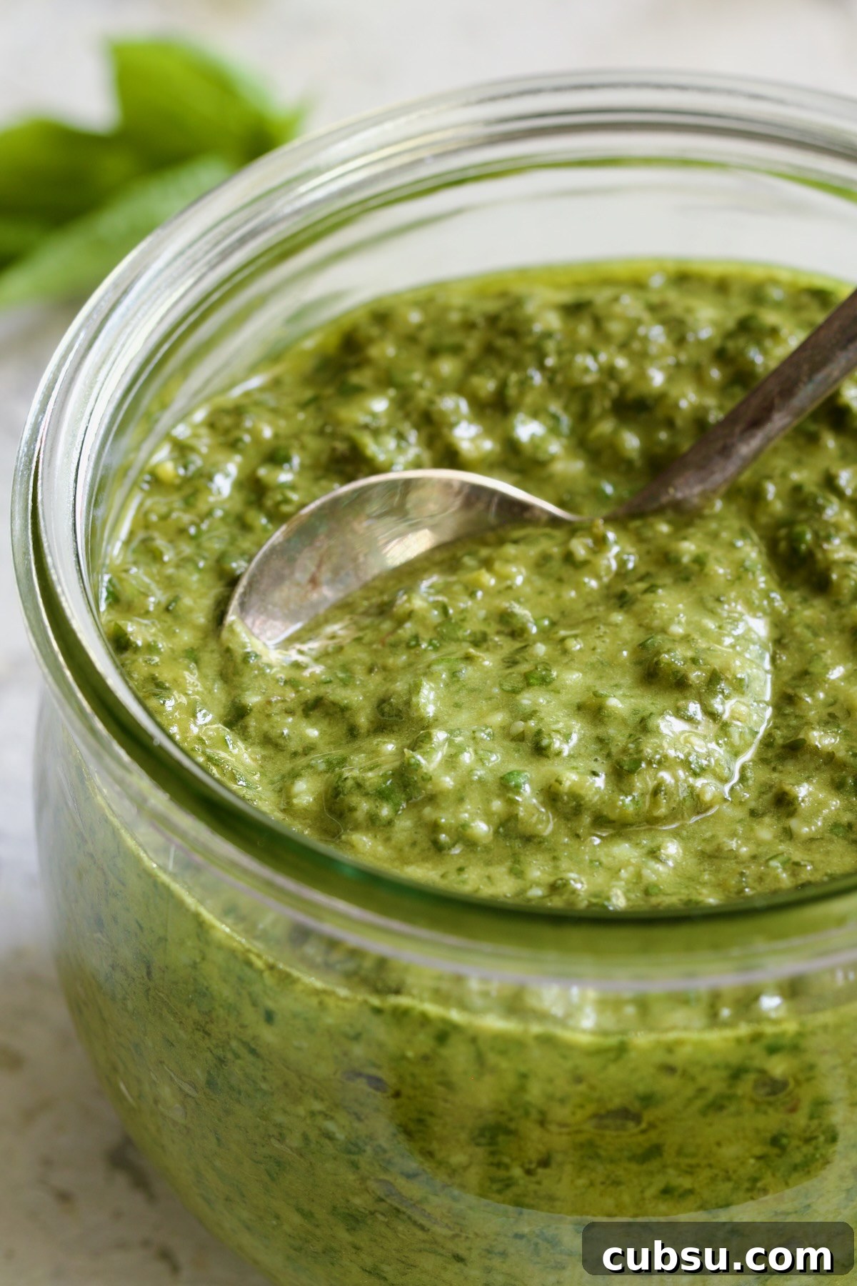Jar of Pesto Genovese with spoon.