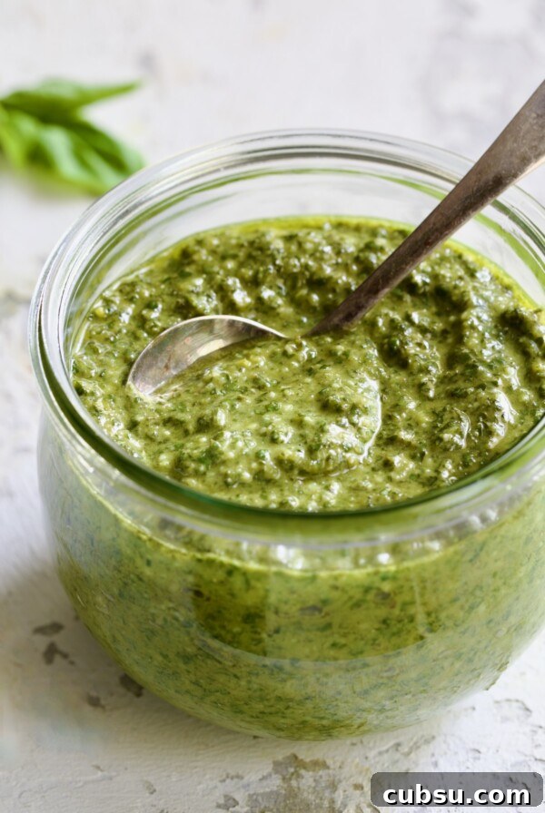 Jar of Pesto Genovese with spoon.