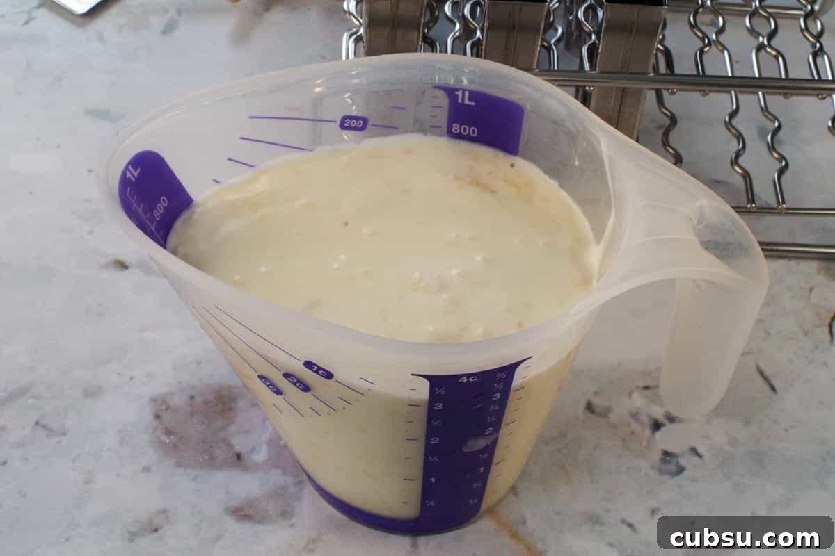 Popsicle ingredients in a large plastic pourable measuring cup