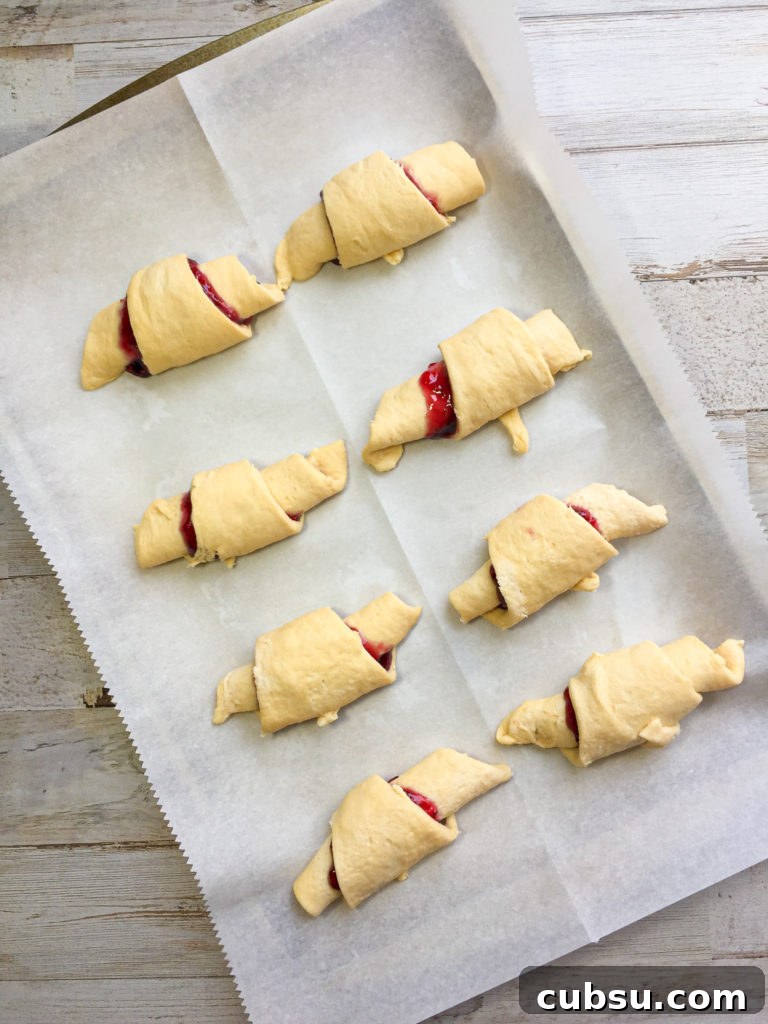 Razzleberry Crescent Rolls: Flaky Fruit-Filled Pastries Tutorial 6 Rolled crescent rolls on baking sheet