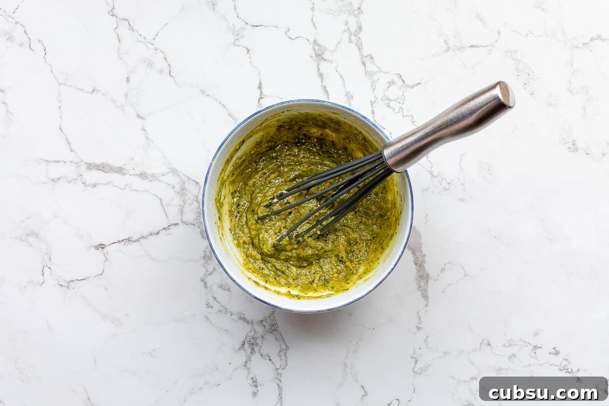 pesto sauce in bowl with whisk