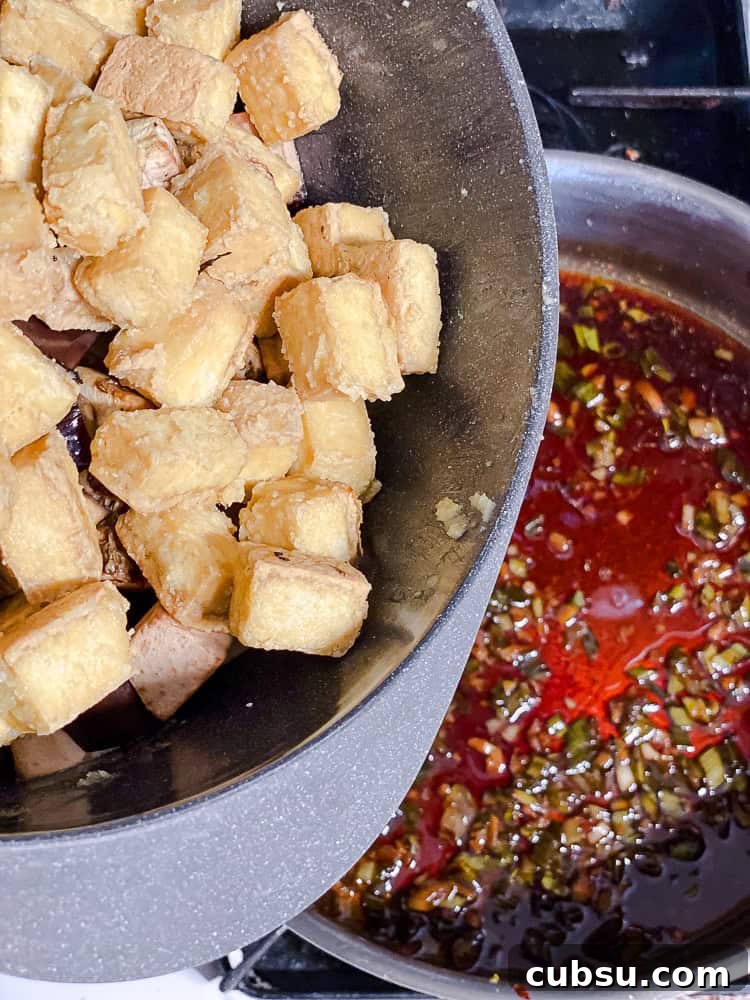 process shot showing tofu being added to pan