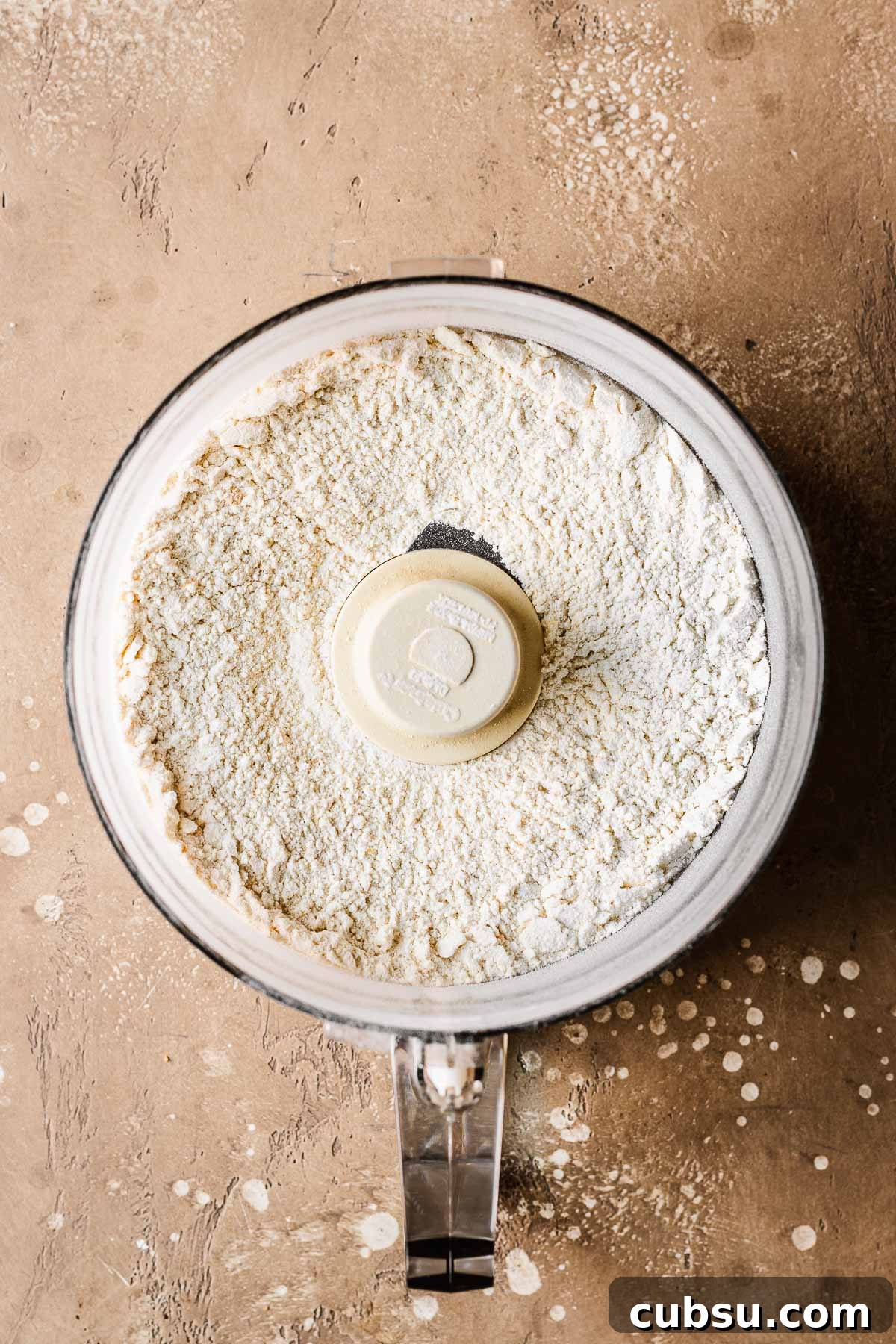 Dry ingredients for cookie dough in a food processor.