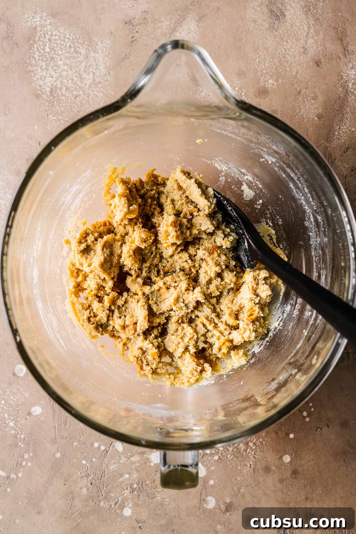 Final dough for mango cookies in a clear glass mixing bowl.