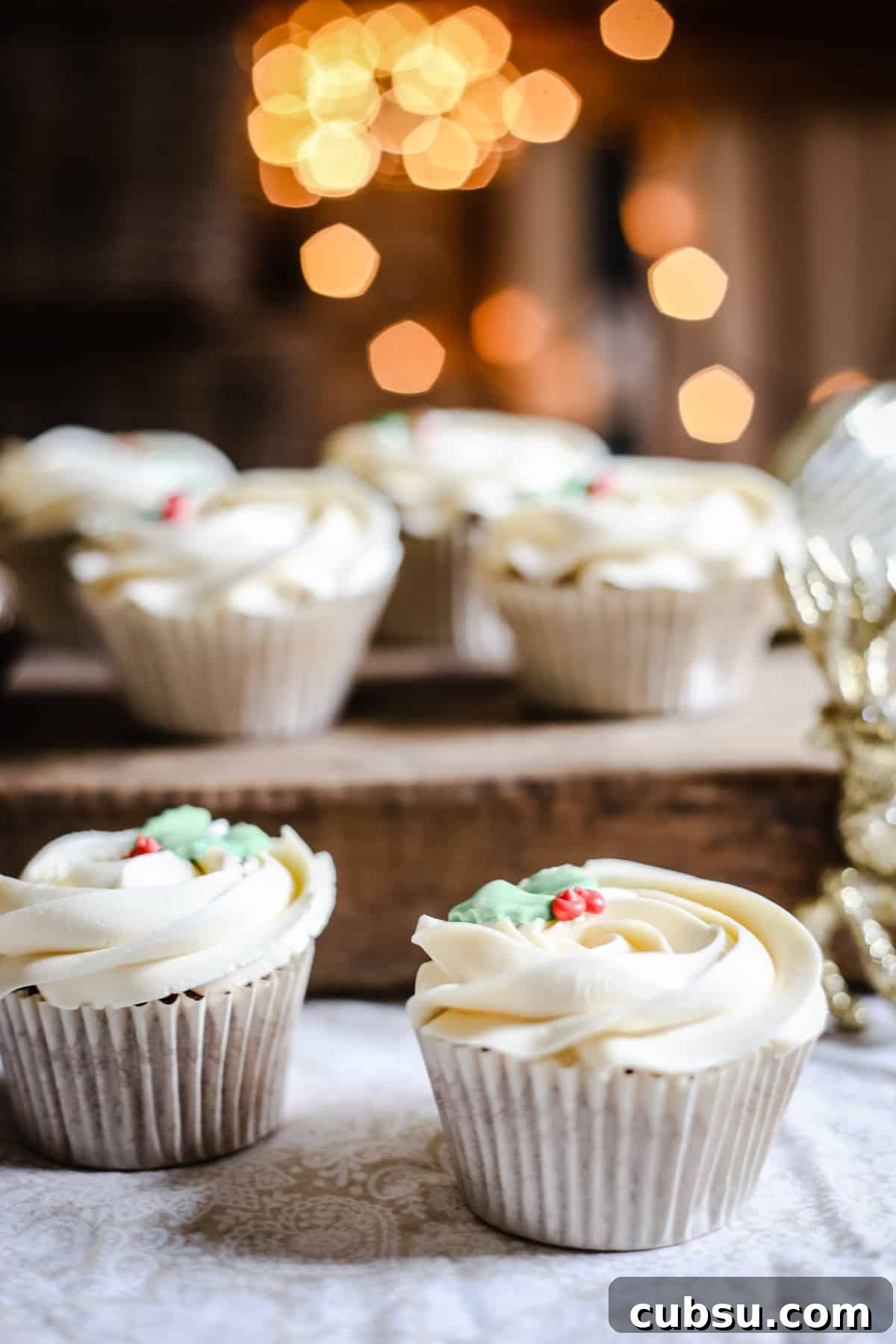 Mince Pie Cupcakes surrounded by christmas decorations and twinkling lights