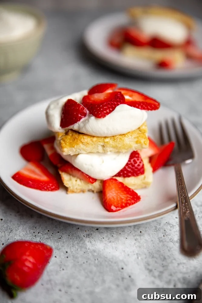 Close up of an gluten-free strawberry shortcakes on a plate with a fork. 