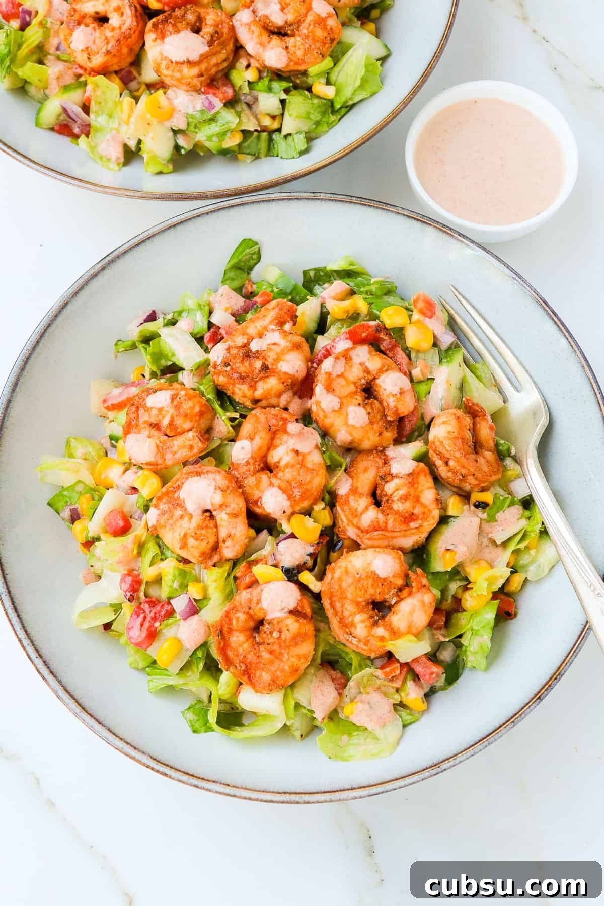 Zesty Cajun Shrimp Salad with Avocado and Lime Dressing 12 Side shot of cajun shrimp salad in a bowl.