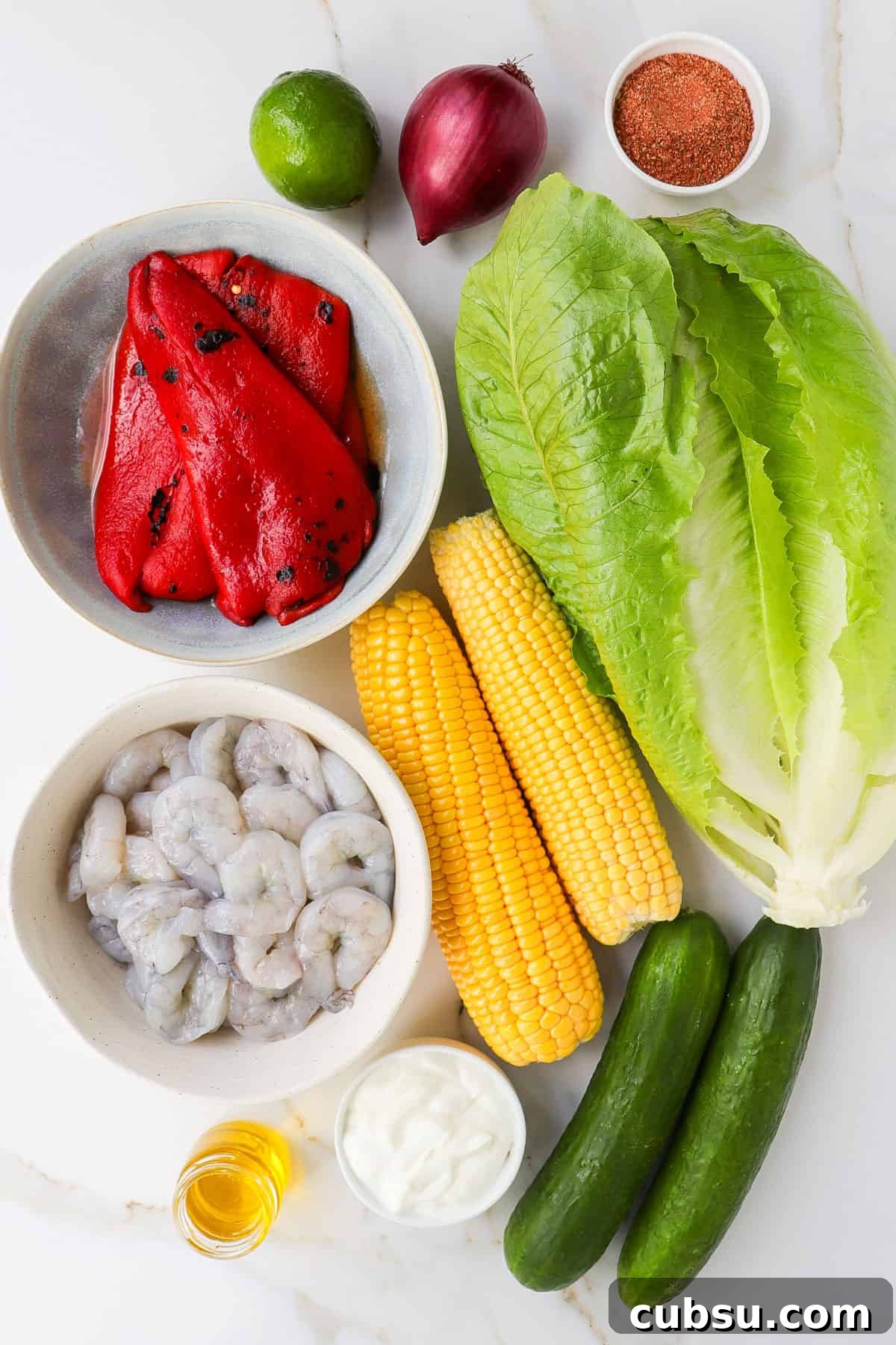 Zesty Cajun Shrimp Salad with Avocado and Lime Dressing 4 Ingredients shown to make the salad.