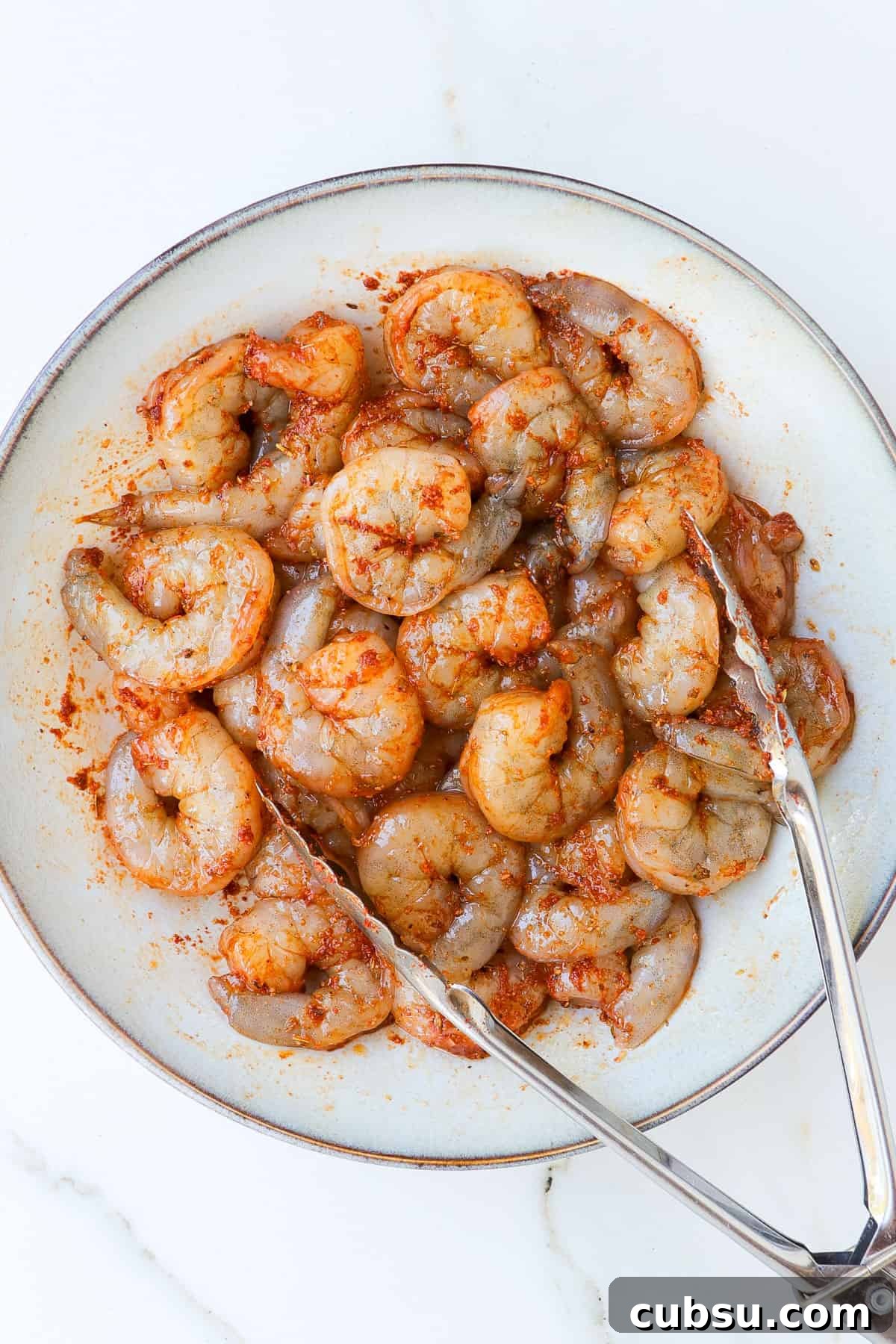 Zesty Cajun Shrimp Salad with Avocado and Lime Dressing 5 Shrimps marinating in seasonings.