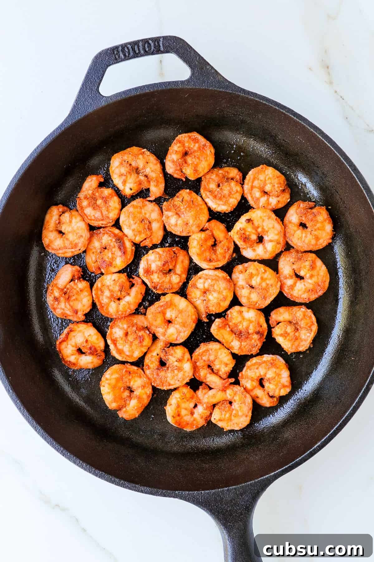 Zesty Cajun Shrimp Salad with Avocado and Lime Dressing 8 Cajun shrimps in a skillet.