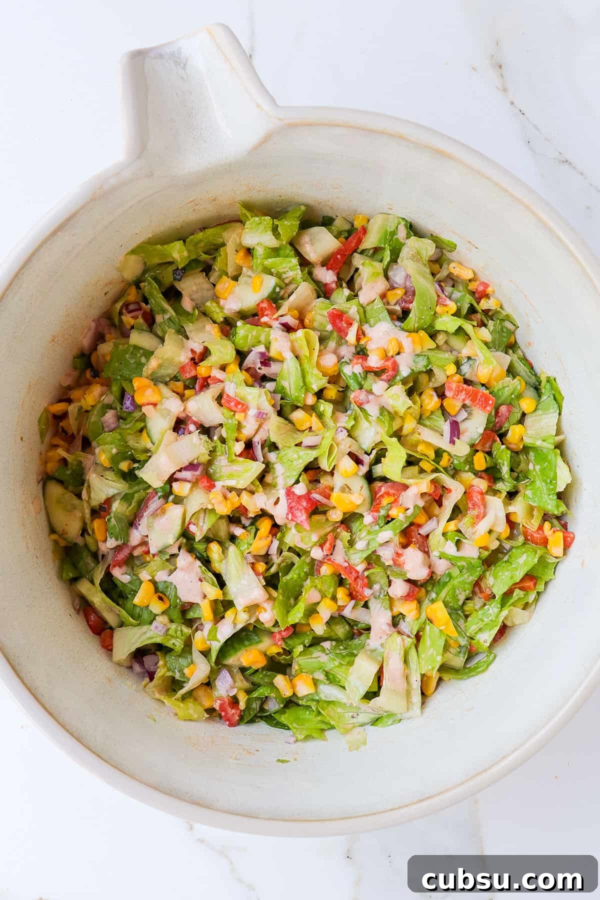 Zesty Cajun Shrimp Salad with Avocado and Lime Dressing 10 Grilled corn salad in a mixing bowl.