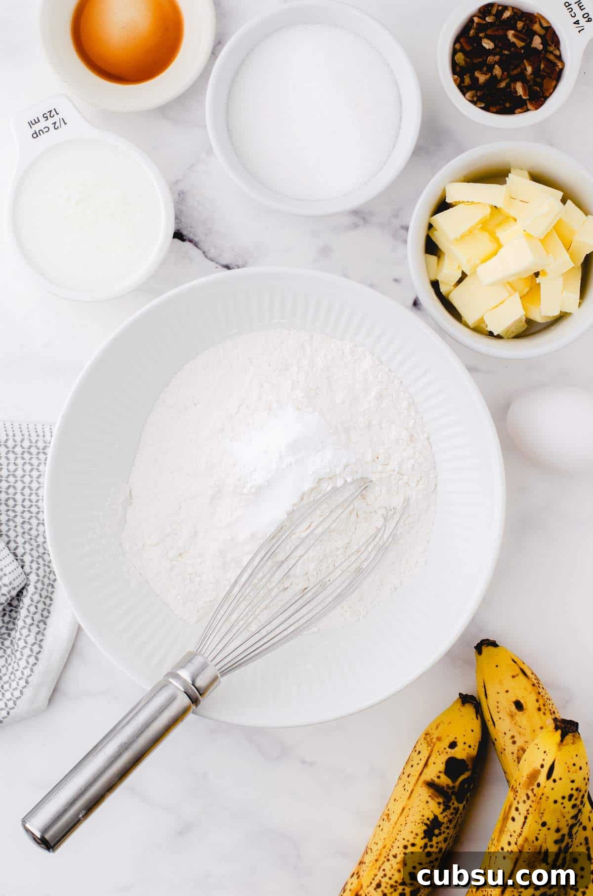 A white bowl of the dry ingredients for buttermilk banana bread.