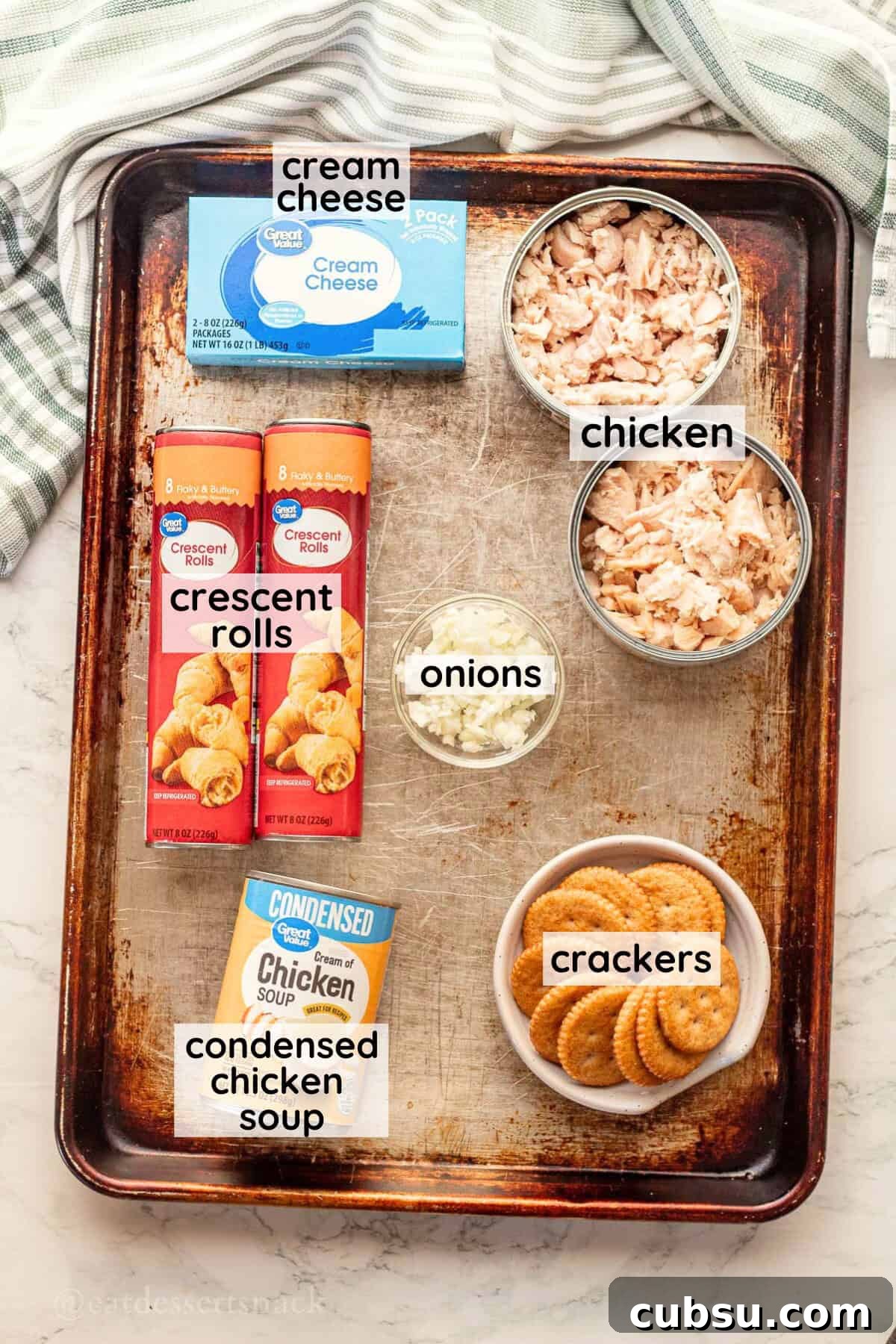 Labeled ingredients for chicken roll ups on metal pan in glass bowls.