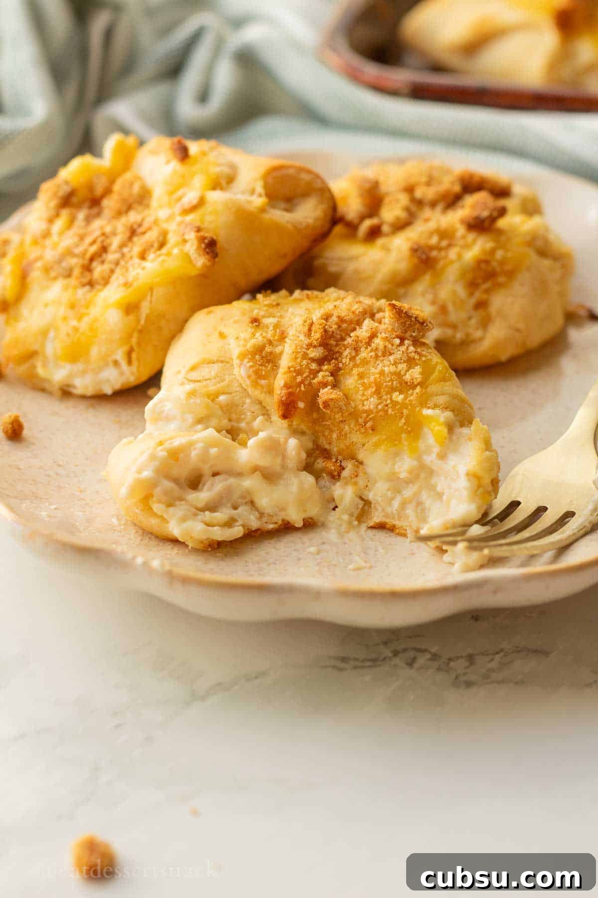 Bite out of chicken roll up on white plate.