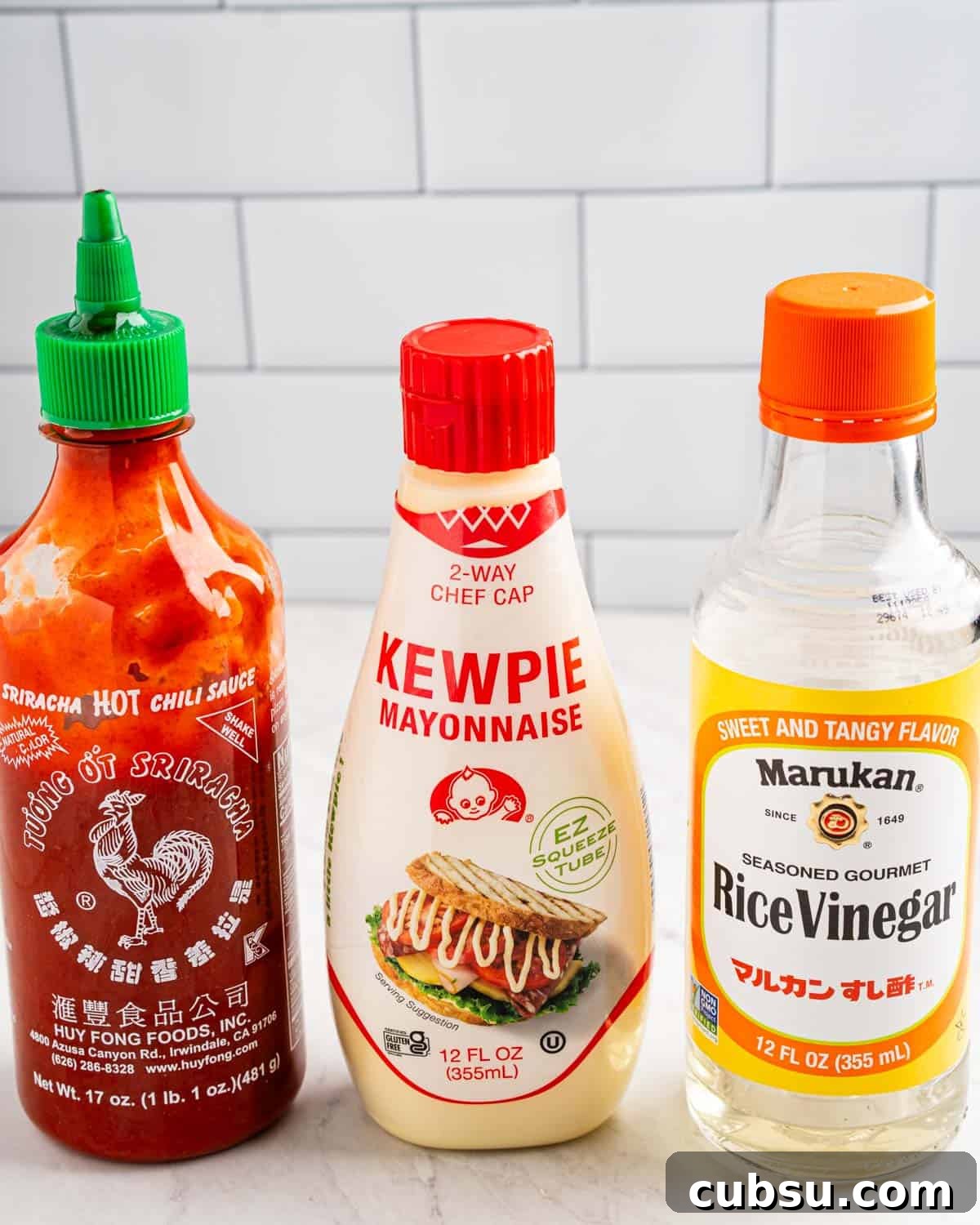 jars of sriracha, kewpie mayo, and rice vinegar to make sauce for salmon bites.