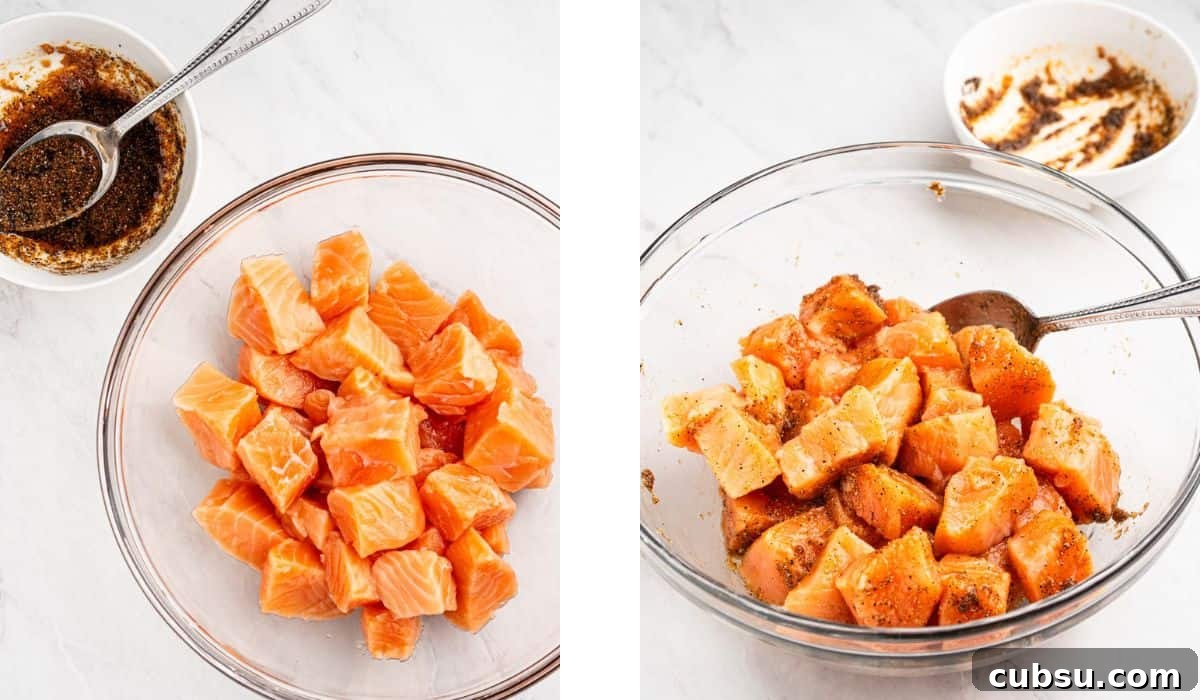 Process of seasoning the salmon cubes in a mixing bowl.