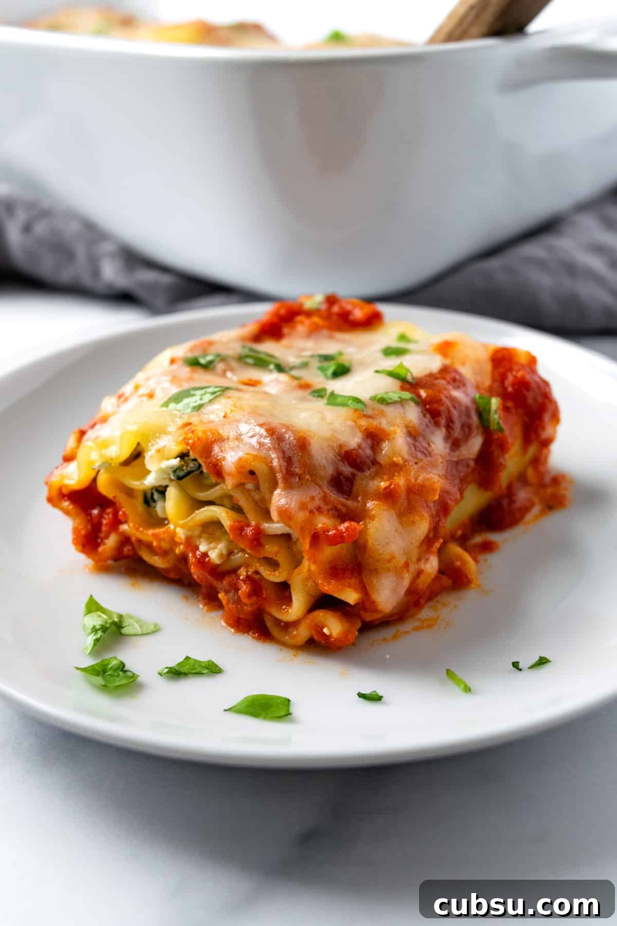Cheesy Spinach Lasagna Rolls with Ricotta Filling 2 A Spinach Lasagna Roll on a Plate.