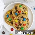 Soft Chewy Gluten-Free M&M Cookies recipe 11 Overhead view of three gluten-free M&M cookies on a plate