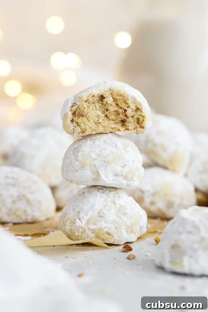 Soft Chewy Gluten-Free M&M Cookies recipe 8 gluten-free snowball cookies stacked in a column